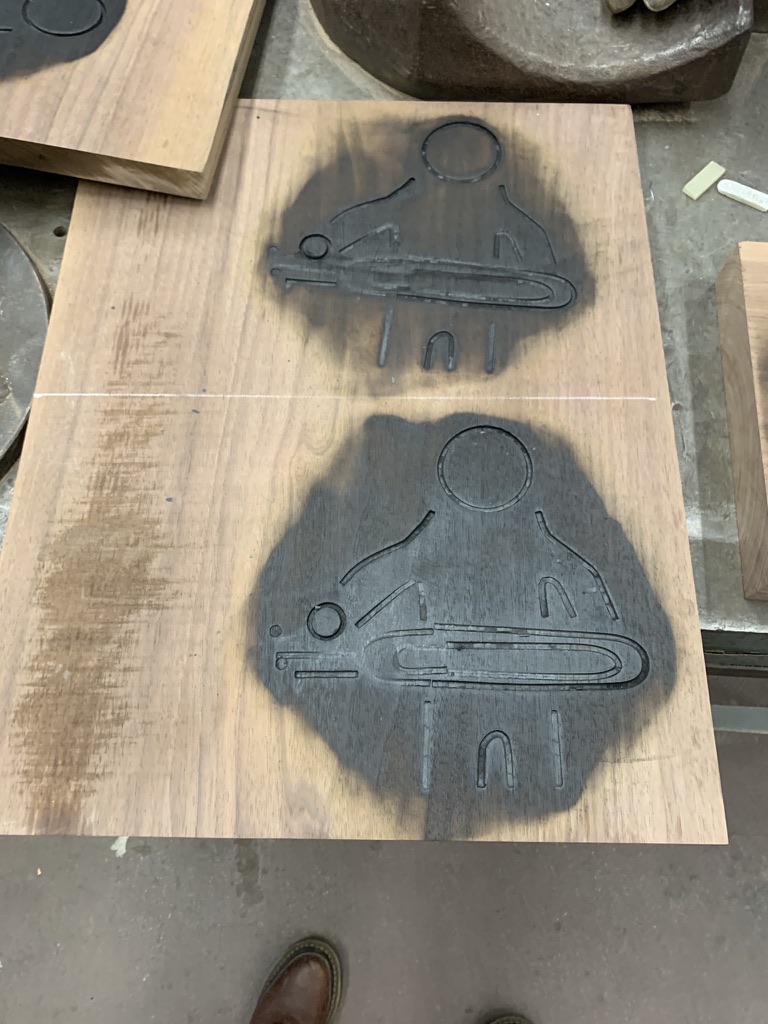 Wood board with two test brand marks from the custom iron