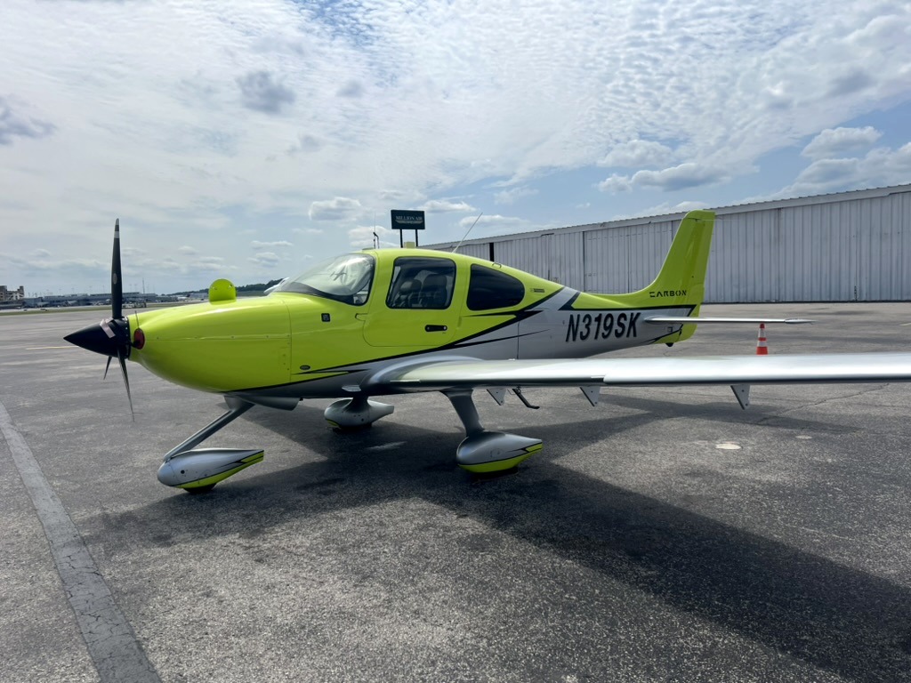 Cirrus SR20 on the tarmac in lime green and silver paint