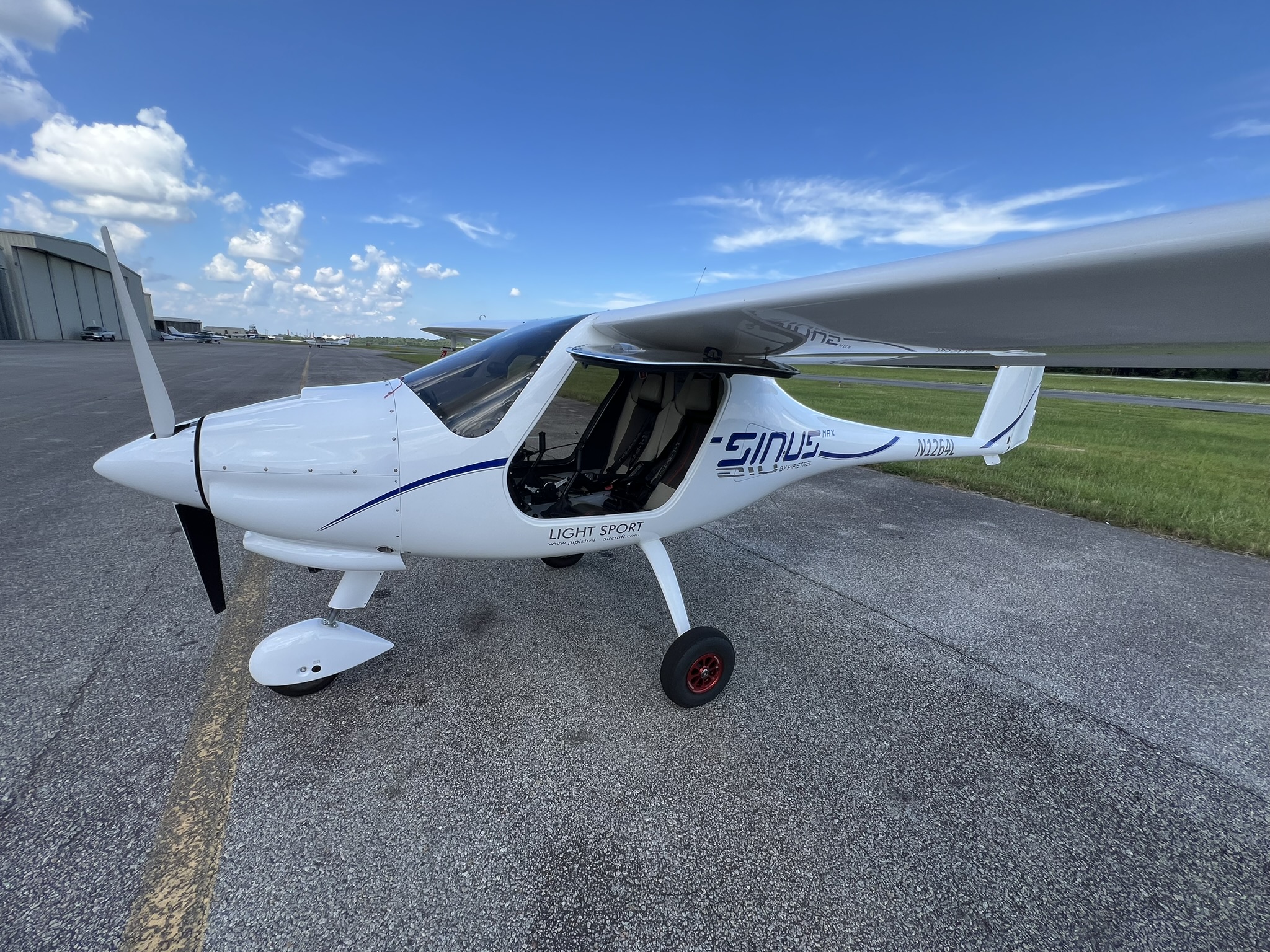 Pipistrel Sinus Max light-sport aircraft on the apron with the cabin door open